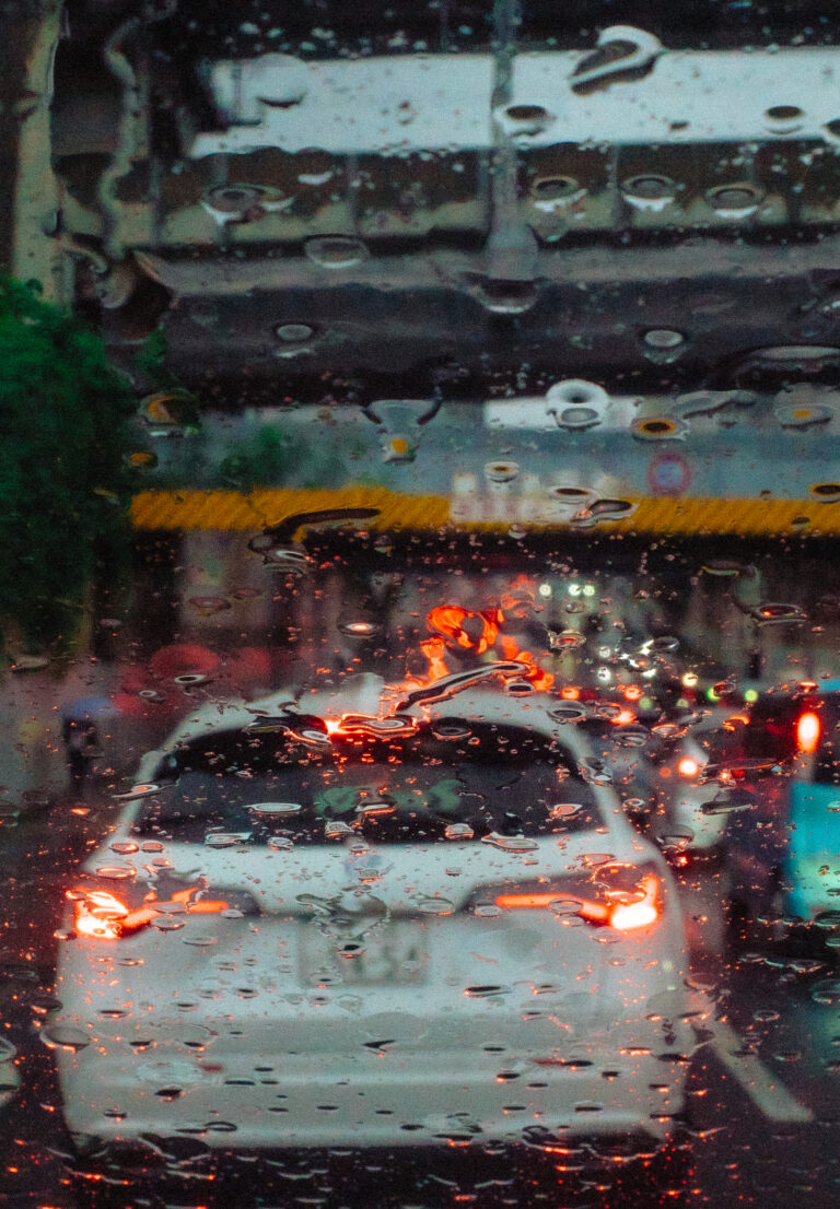 Traffic lights seen through a rain-streaked window.